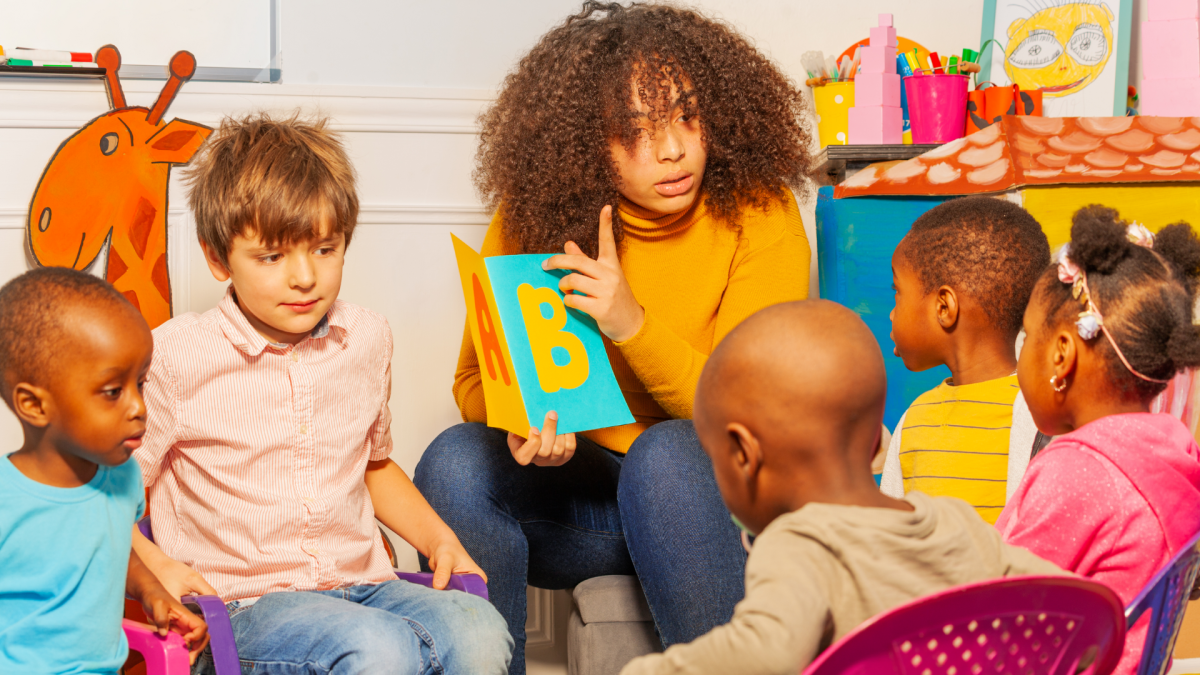 Children surround librarian reading a story book